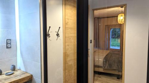 a glass door leading into a bathroom with a shower at La Ferme du Château in Beire-le-Châtel