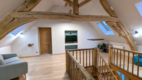 a living room with wooden floors and wooden beams at La Ferme du Château in Beire-le-Châtel
