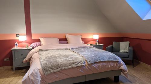 a bedroom with a large bed and a chair at La Ferme du Château in Beire-le-Châtel