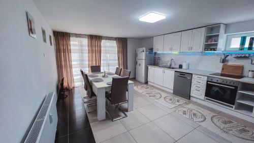 a large kitchen with a table and chairs in it at Cozy Apartman in Leisbach 