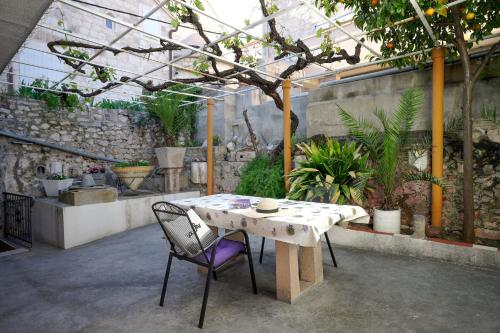 a table and chairs in a greenhouse with plants at Central Eden - ZF Hvar in Hvar