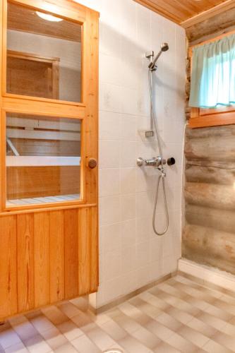 a bathroom with a shower with a glass door at Suommukelo 5 View of the slopes Incl Sauna, A heated ski service room in Suomutunturi