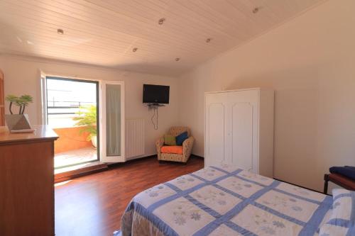 a bedroom with a bed and a tv on the wall at B&b SAN LORENZO in Conversano
