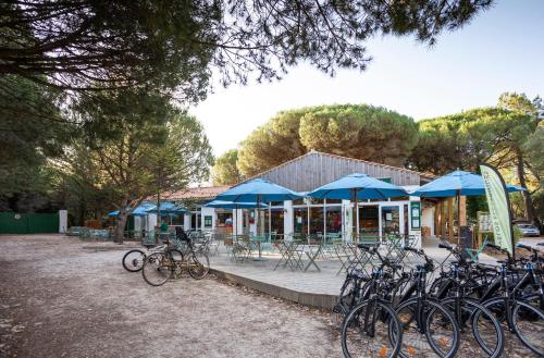a group of bikes parked in front of a building at Huttopia Chardons bleus Ile de Re in Sainte-Marie-de-Ré