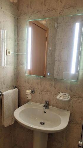 a bathroom with a sink and a mirror at Ferrinho in Guarda