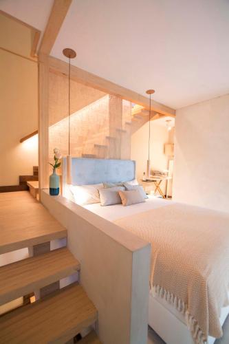 a bedroom with a large bed and a staircase at The Wooden House VV in Las Palmas de Gran Canaria