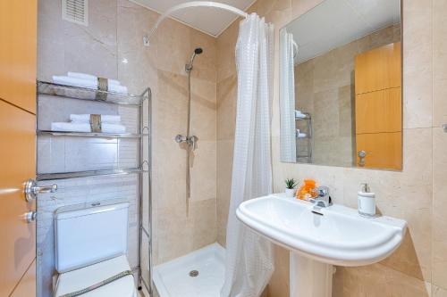 La salle de bains est pourvue d'un lavabo, d'une douche et de toilettes. dans l'établissement 797 HOLIDAY RENTALS - Piso en arenal con vista al golf y mar, à Benalmádena