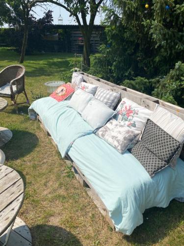 a couch sitting on the grass in a yard at L’hirondelle du Faubourg in Saudemont