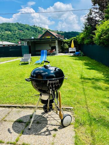 a grill sitting on a stand in a yard at Ferienhaus Sausalblick in Großklein