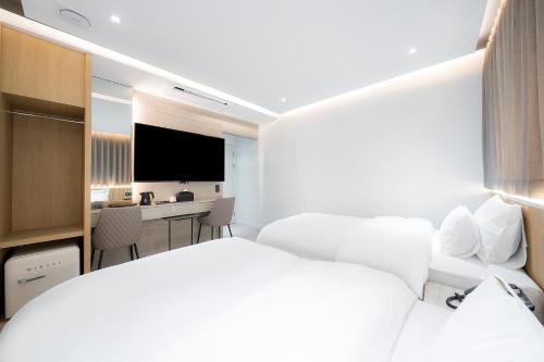 a hotel room with a bed and a desk at Brown Dot Hotel Pyeonghwa plaza in Mokpo