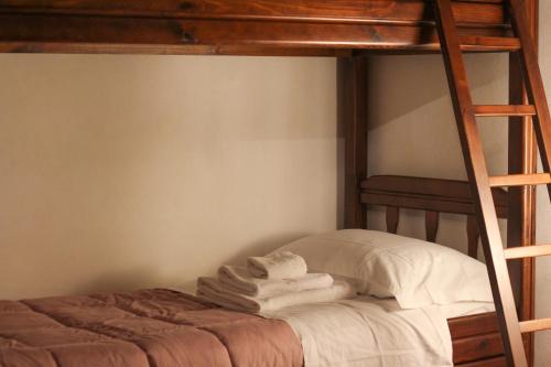 a stack of towels sitting on top of a bunk bed at Santo'S House BnB in Santo Stefano di Sessanio