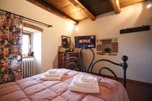 a bedroom with a bed with two towels on it at Santo'S House BnB in Santo Stefano di Sessanio