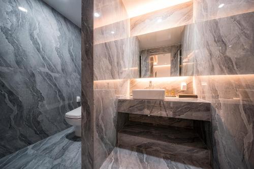 a bathroom with a sink and a toilet at Brown Dot Hotel Pyeonghwa plaza in Mokpo