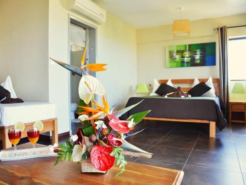 a living room with a couch and a table at Happy Days Guest House in Le Morne