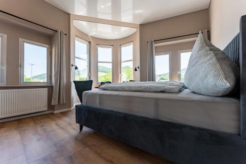 a bedroom with a bed with pillows on it at Moselresidenz Bellevue Alf Apartment Moselblick in Alf