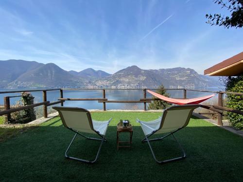 2 sedie e un tavolo con vista sull'acqua di Casa Vista lago - 24h Check in - Free WiFi - Netflix a Monte Isola