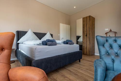 a bedroom with a large bed with blue furniture at Moselresidenz Bellevue Alf Apartment Moselblick in Alf