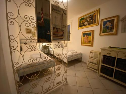 a room with two beds and a mirror at Casa Vista lago - 24h Check in - Free WiFi - Netflix in Monte Isola