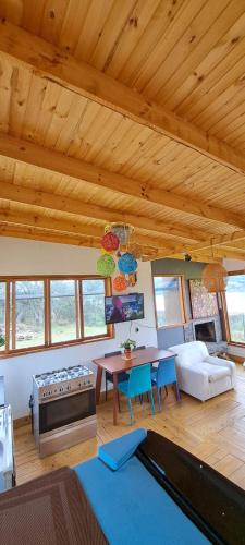 a living room with a table and a couch at Villa Vista in Guatavita