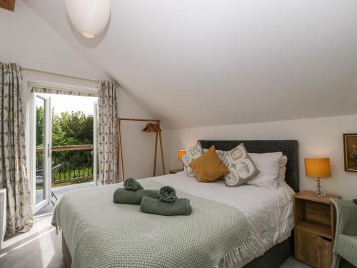 a bedroom with two beds and a window at The Loft At Nordrach Lodge in Bristol
