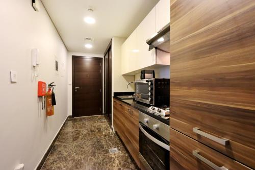 A kitchen or kitchenette at Livbnb Sparkling Studio Retreat in Heart of Dubai