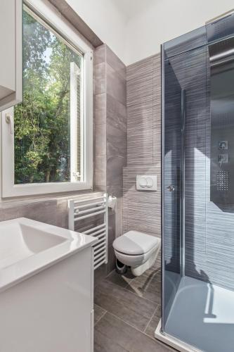 a bathroom with a toilet and a sink and a shower at Villa Carolina in Rijeka