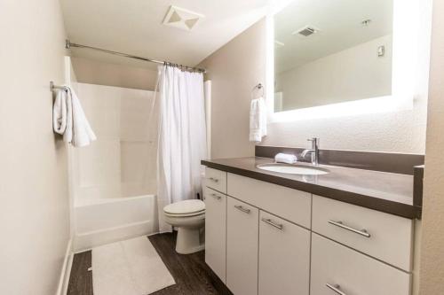 a white bathroom with a sink and a toilet at Sunny 2BDR 5 min to SM Pool and Gym Free Parking in Los Angeles