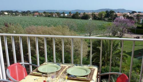 - une table sur un balcon avec vue sur un champ dans l'établissement T2 ensoleillé, vue mer et champ, climatisé, à Carqueiranne