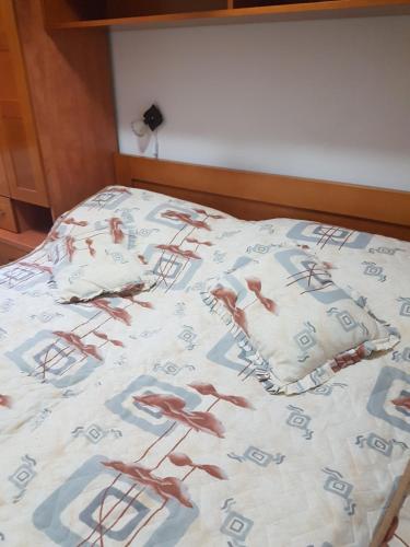a bed with a bedspread with crabs on it at Apartment Joksimovic in Zlatibor