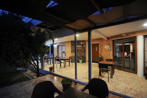 an outdoor patio with tables and chairs at night at Bella Rosa hotel Cyprus in Coral Bay
