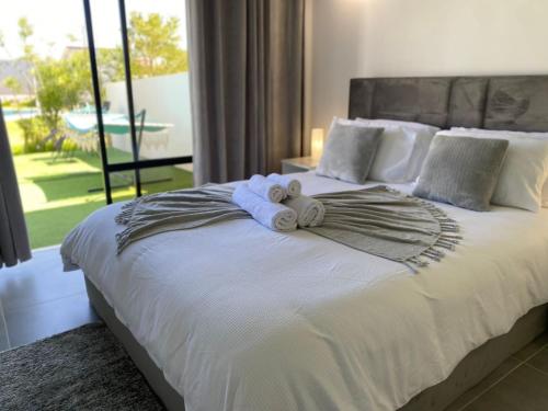 a bedroom with a bed with a stuffed animal on it at Casa com terraço e piscina Sagres in Sagres
