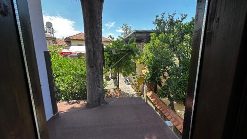 an open door to a house with a tree at Sultan Pension in Antalya