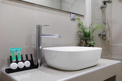 a white sink sitting on a counter in a bathroom at Villa Dionysia Studio S7 in Alikanas
