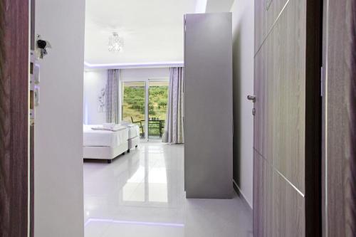 a hallway with a bed and a room with a window at Villa Dionysia Studio S7 in Alikanas