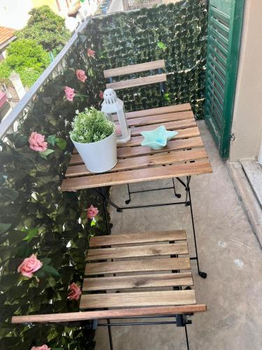 una mesa de madera y un banco con una planta en el patio en Grandchildren's house, en La Spezia