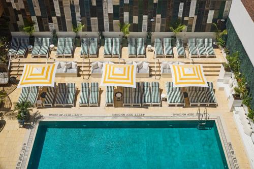 an overhead view of a swimming pool with lounge chairs and a pool at CODA Williamsburg in Brooklyn