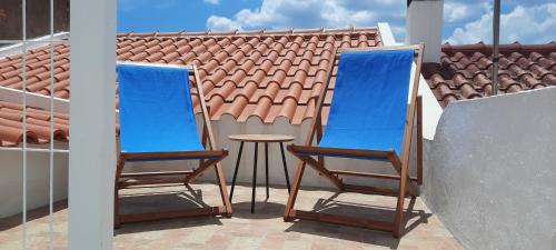 a pair of chairs and a table on a balcony at Casa Esmar in Odemira