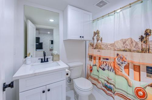 La salle de bains est pourvue de toilettes et d'un rideau de douche tigre. dans l'établissement Tiger Motel Studio Apartment, à Galveston
