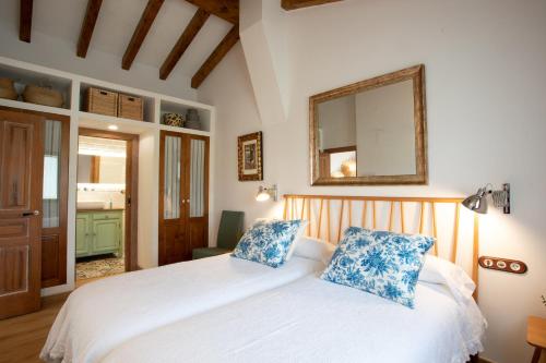 a bedroom with two beds and a mirror on the wall at Miraverde Liérganes in Liérganes