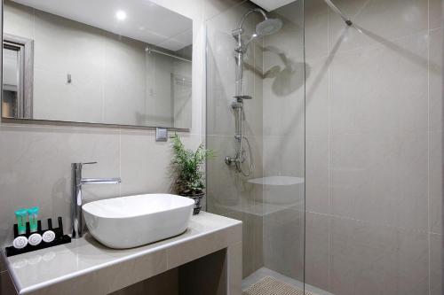 a bathroom with a sink and a glass shower at Villa Dionysia Studio S5 in Alikanas