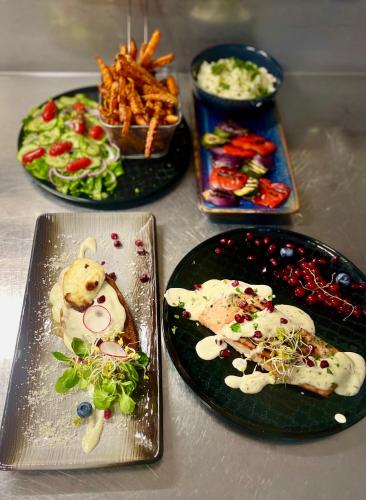 a table with three plates of food on it at Piano in Nowy Sącz