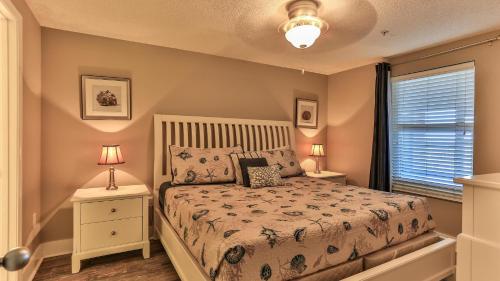 a bedroom with a bed and two night stands at Majestic Sun 1006B in Destin