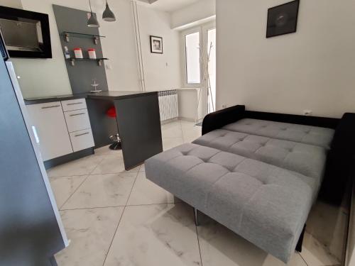 a living room with a couch and a kitchen at Biuk Apartments in Novi Vinodolski