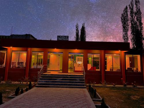 a building with a starry sky in the background at Desert One Hotel Skardu in Skardu