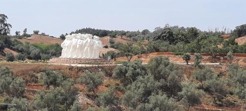 a large white statue in the middle of a field at Casa Esmar in Odemira