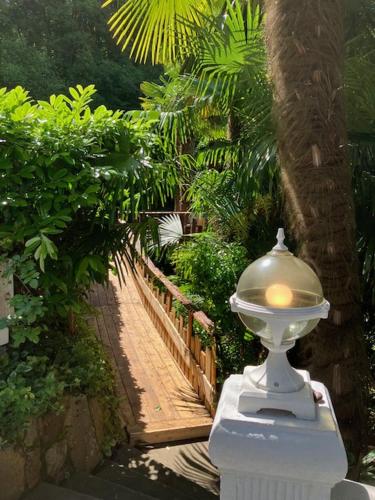 a white lamp sitting on the side of a walkway at L'AUBERGE DE LA GOUTILLE in Capvern