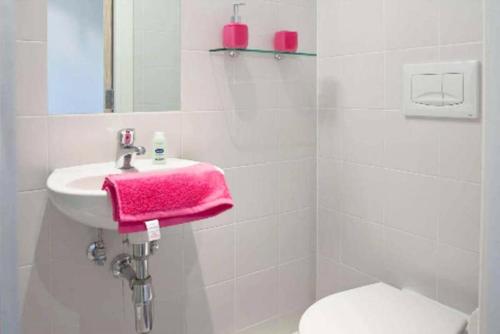 a bathroom with a sink and a pink towel at Edinburgh College Residence in Edinburgh