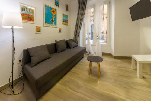 una sala de estar con un sofá y una mesa en APARTAMENTOS MAPAMUNDI, en Badajoz