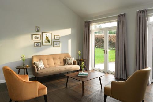 a living room with a couch and chairs and a window at SCHLOSS Roxburghe, part of Destination by Hyatt in Kelso
