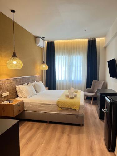 a bedroom with a bed and a desk and a chair at G&W Luxury Rooms in Athens